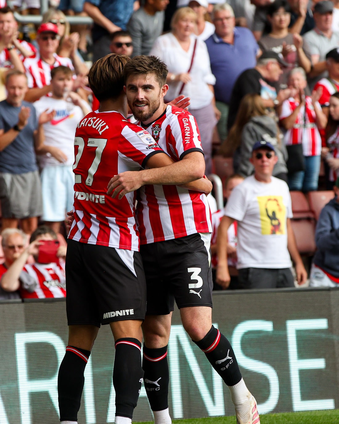 Southampton players celebrating a goal in front of the VARIANSE board at St Mary's